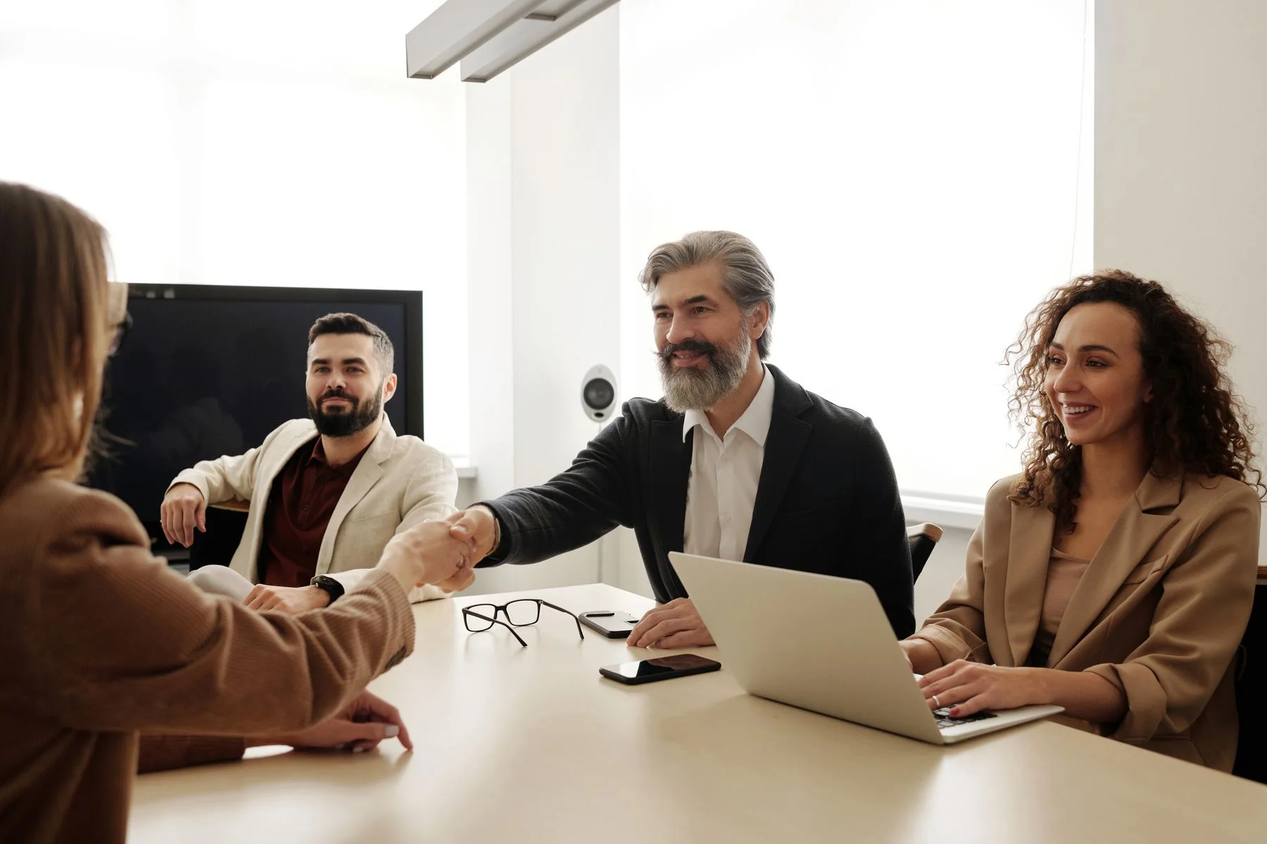 Business professionals getting to know one another over a handshake
